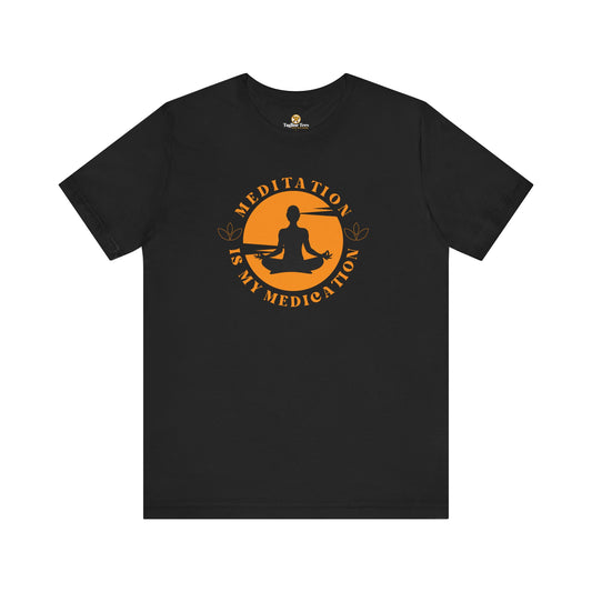 Black t-shirt with a colorful design featuring a meditating figure and text on orange retro sunset background